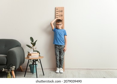 Little Boy Measuring Height At Home