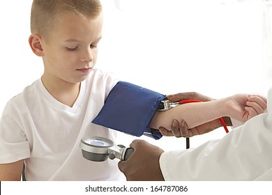 Little Boy Medical Visit - Doctor Measuring Blood Pressure Of A Child 