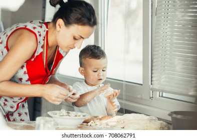 Little Boy With Mom In The Kitchen Preparing Flour From Those Of The Test Dish, Dumplings