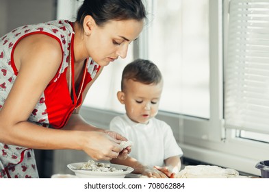 Little Boy With Mom In The Kitchen Preparing Flour From Those Of The Test Dish, Dumplings