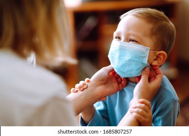 Little boy and mom in medical mask. Mother puts on her baby sterile medical mask. Child, wearing face mask, protect from infection of virus, pandemic, outbreak and epidemic of disease on quarantine. - Shutterstock ID 1685807257