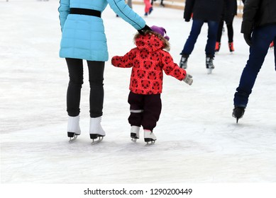 Little Boy With Mom Skate At The Ice Rink In Winter. A Woman Is Teaching Her Child To Skate. Sports Clubs, Active Family Sport, Entertainment For Children On Winter Holidays, New Year
