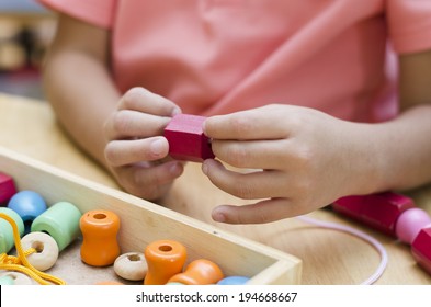 Little Boy With Montessori Material Colored Beads 