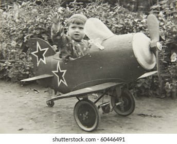 A Little Boy On The Plane, An Old Picture Of 40 Years Of XX Century.