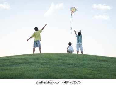 Little boy on summer vacation having fun and happy time flying kite on the sea beach