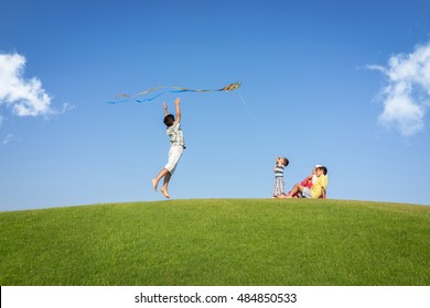 Little boy on summer vacation having fun and happy time flying kite on the sea beach - Shutterstock ID 484850533