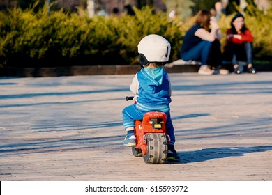 Little boy on a toy motorcycle