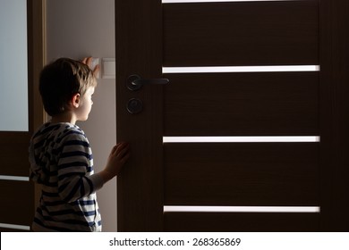 Little Boy Opens The Door To The Room By Night