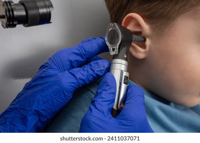  a little boy in the otolaryngologist's office, an examination of the ears by a doctor, an examination, an ear plug, a hearing test. Health check. Close up view - Powered by Shutterstock