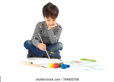 Little Boy Painting Against White Background