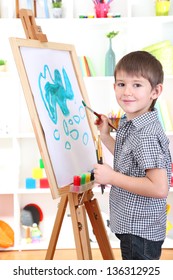 Little Boy Painting Paints Picture On Easel