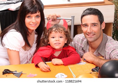 Little Boy And Parents Getting Ready For Halloween