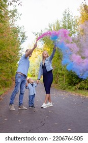 Little Boy With Parents On Gender Party With Colorful Smoke