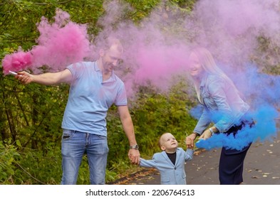 Little Boy With Parents On Gender Party With Colorful Smoke