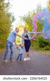 Little Boy With Parents On Gender Party With Colorful Smoke