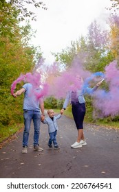 Little Boy With Parents On Gender Party With Colorful Smoke