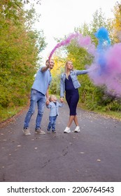 Little Boy With Parents On Gender Party With Colorful Smoke