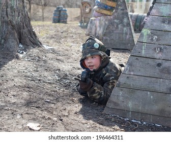 Little Boy Player With Gun During Laser Tag Game.