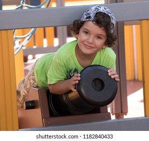 Little Boy Playing With A Cannon Ball In The Park.