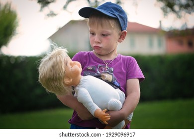 Little Boy Playing With A Doll In Nature 2021