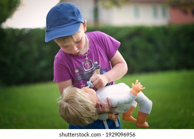 Little Boy Playing With A Doll In Nature 2021