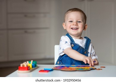 A Little Boy Is Playing Educational Logic Games. Children's Wooden Toys. Sorter. Montessori For Child Development.