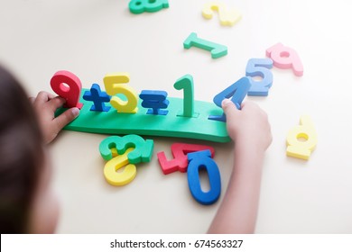 Little Boy Playing With Figures, Early Education, Mathematics And Numeracy. Top View No Face. Close-up. - Image  