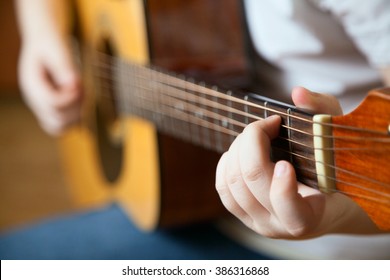 Little boy is playing the guitar
