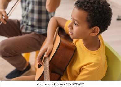 Little Boy Playing Guitar At Music School