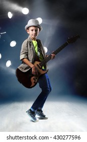 Little Boy Playing Guitar On Stage