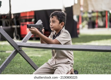 little boy playing with guns and learning the history of warfare march 1st general attack. : Yogyakarta, Indonesia - 01 March 2022