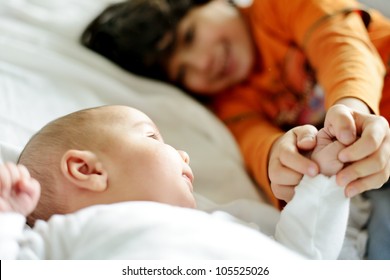 Little Boy Playing With His New Newborn Baby Brother