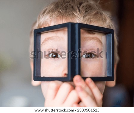 Child with reading magnifier