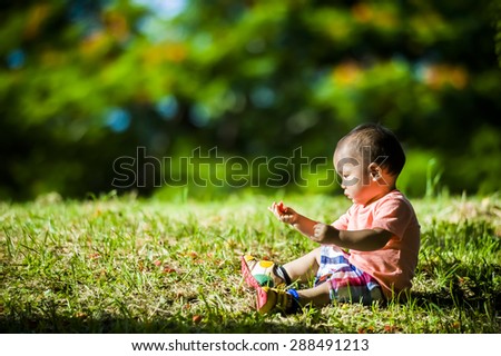 a little boy playing in nature