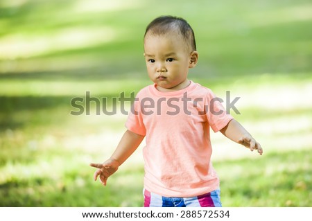 a little boy playing in nature