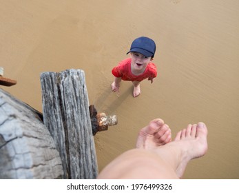 Little Boy Playing On The Beach In The Water Birds Eye View Of Child On Sand