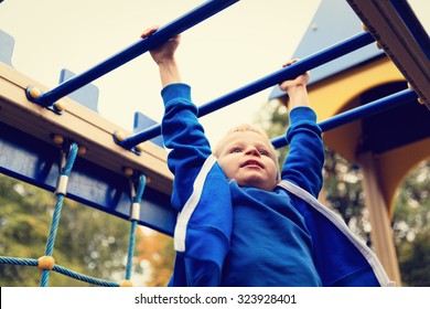little boy playing on monkey bars in autumn, kids sport - Powered by Shutterstock
