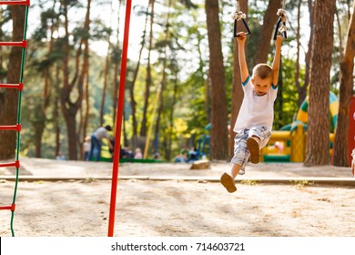 little boy playing on monkey bars in autumn, kids sport - Powered by Shutterstock