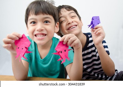 Little boy playing on paper art origami