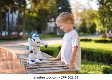little boy playing outside with a robot - Powered by Shutterstock