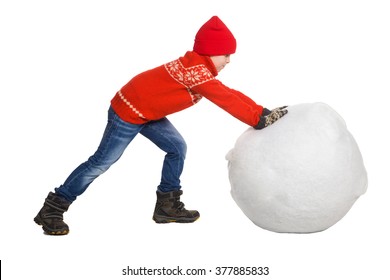 Little Boy Playing In The Snow, Isolated On White Background. Children In Winter. Happy Kid Making A Big Snowball For Snowman 