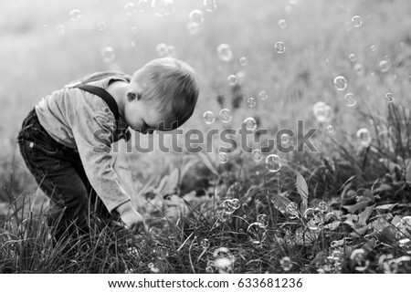 Similar – Adorable little girl playing with a ball sitting on a park bench