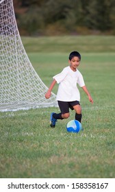 Little Boy Playing Soccer