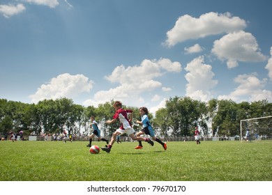 Little Boy playing soccer on the sports field - Powered by Shutterstock