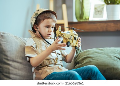 Little Boy Playing Soldiers In Living Room. Child Is Playing With Toy. Knights And Battles - Favorite Game For Boys. Entertainment For Kids Indoors. Offline Games. Boy Playing With Toy Helicopter