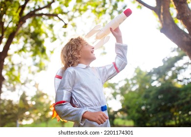 Little Boy Playing With Spaceship. Astronaut Costume For Halloween Party. Creative Child With Space Rocket. Kids Dream And Imagine. Role Play For Children. Future And Freedom Concept.