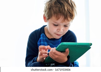 Little boy playing with tablet. Child using technology playing games or learning
