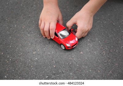 Little Boy Playing With Toy Car Outdoor