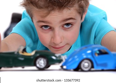 Little Boy Playing With Toy Cars