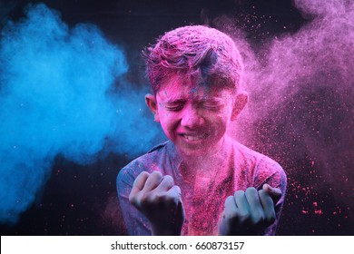 Little boy plays with colors.Concept for Indian festival Holi.